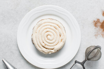 Overhead view of vanilla frosting coated cookies, top view of vanilla cookies with a vanilla cream frosting, process of making bakery style cookies