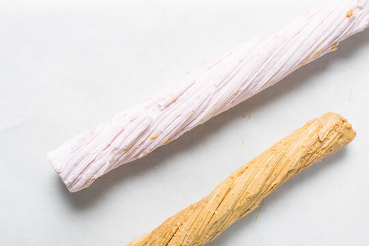 Overhead view of Nigerian Balewa candy, top view of hausa alewa candy on a white background, pulled hard sugar candy on a white countertop