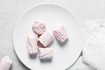 Overhead view of Nigerian Balewa candy, top view of hausa alewa candy on a white background, pulled hard sugar candy on a white countertop