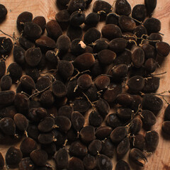 Overhead view of velvet tamarind on a white countertop, top view of velvet tamarind bunch on white background