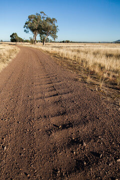 Corrugated gravel and dirt road driveway on farm