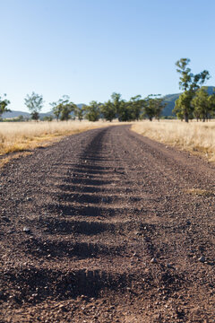 Corrugated gravel and dirt road driveway on farm