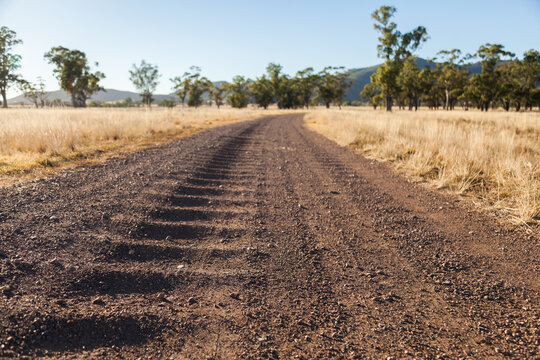 Corrugated gravel and dirt road driveway on farm