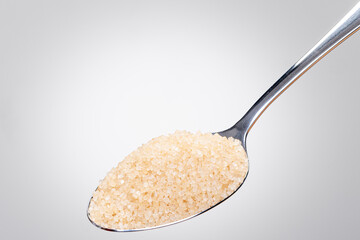 Rustic Spoon with Raw Brown Sugar – Isolated White Background