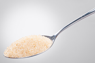 Rustic Spoon with Raw Brown Sugar – Isolated White Background