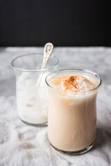Coffee with ice cream and cinnamon in glass cup. Selective focus.