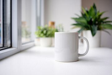 White Mug on a Light Table with Greenery