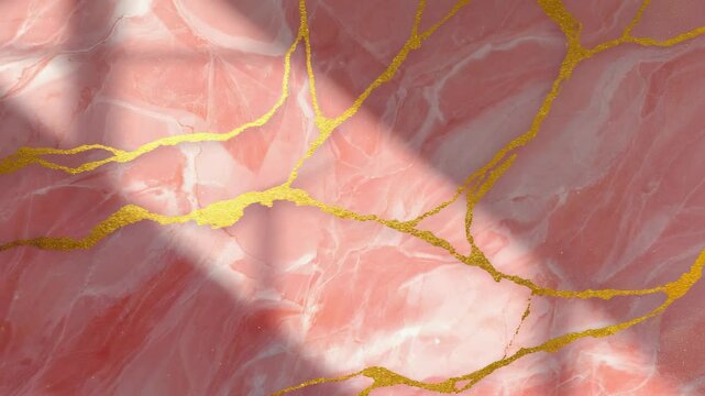 Luxury pink marble stone with gold accents creating a textured and elegant pattern, suitable for background or decoration.