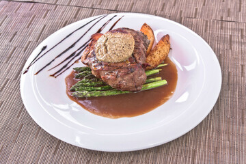 Fillet Rossini, Tournedos Rossini with foie gras, asparagus, and fries. Filet mignon. Served in the restaurant. Lunch