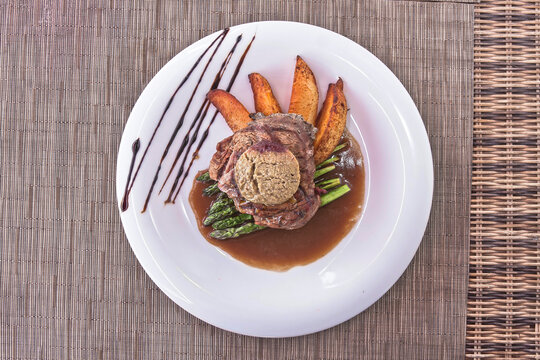 Fillet Rossini, Tournedos Rossini with foie gras, asparagus, and fries. Filet mignon. Served in the restaurant. Lunch