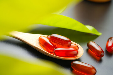 wooden spoon with soft gels, Fish oil capsules, omega 3, omega 9, vitamin D, vitamin E