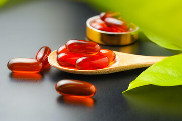 wooden spoon with soft gels, Fish oil capsules, omega 3, omega 9, vitamin D, vitamin E