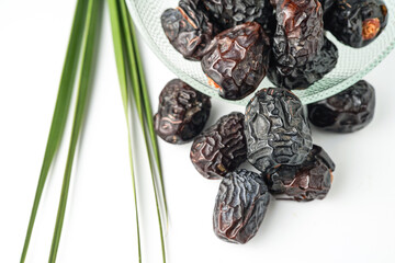 Dates fruit ajwa or kurma ajwa, in bowl isolated on white background