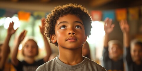 A young boy with brown hair is looking up at the camera