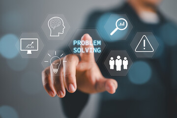 Problem solving concept, Businessman hand touching problem solving icon on virtual screen. Business person concentrated on critical thinking.