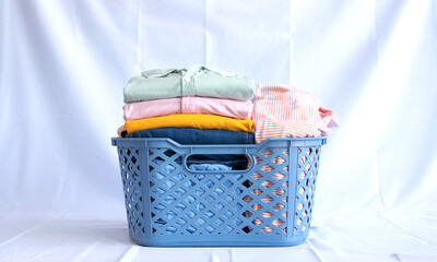 Laundry basket filled with folded clothes clean laundry day household chores domestic life organization tips