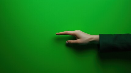 Businesswoman pointing on green screen for sustainability and environmental conservation
