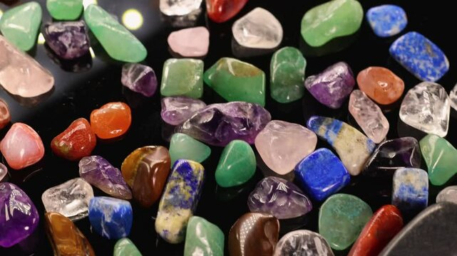 Vibrant Chakra Stones in Motion on Black Background
