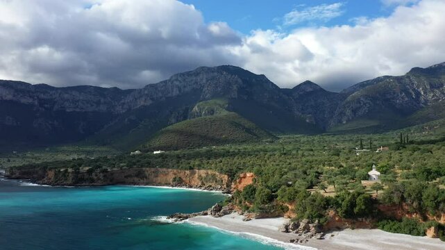 The pebble beach and hills of Paralia near Monemvasia in Europe, Greece, Peloponnese, Arcadia, in summer on a sunny day.&nbsp;