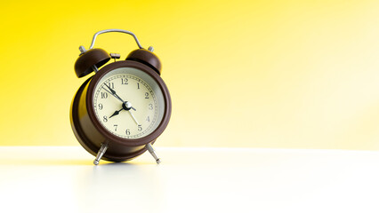 Chocolate Twin Bell Alarm Clock analog classic vintage retro style, isolated on a yellow background, PNG. High resolution. Wide screen