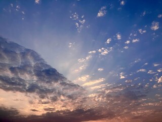 Dramatic Sky Canvas: Sunburst Breaking Through Wispy Clouds on West Lake in Hanoi, Vietnam