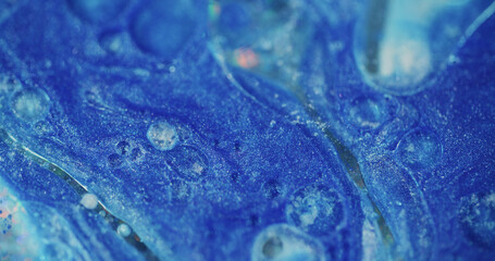 Shiny fluid. Defocused oil liquid. Shimmering blue color gleaming blinking paint flow sparks motion...