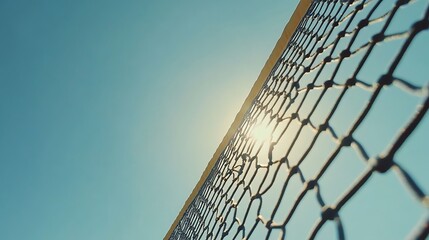 Looking Up at Net Against Blue Sky with Sun
