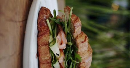 Fresh vegan croissant. Vegan healthy breakfast with delicious croissant. Popular breakfast. Vertical video. Breakfast Croissants with salmon and green salad and cucumbers. - Powered by Adobe