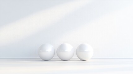Three white spheres against a white wall, minimalist aesthetic
