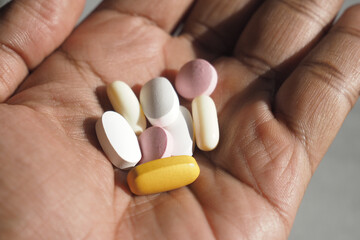 Different types of dietary supplements in a person's hand