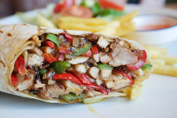 Delicious burrito filled with grilled chicken and fresh vegetables