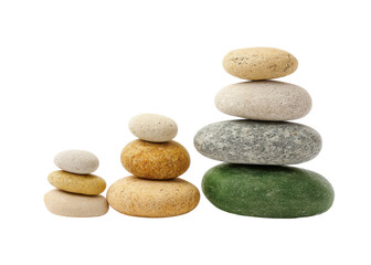Three stacks of balanced stones on a transparent background. Concept of balance, zen, and meditation.