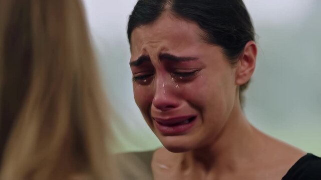 In a serene garden, two individuals engage in a somber dialogue filled with heartfelt emotions. One person displays deep sadness, crying uncontrollably while expressing feelings of pain and