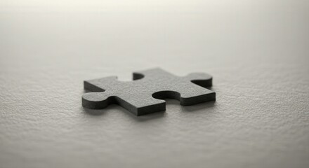single black puzzle piece lying on textured surface, symbolizing solution, problem-solving, and challenge. ideal for concepts like completion or missing piece in strategic projects
