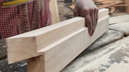 Sanding wood piece for smooth finish in woodworking workshop