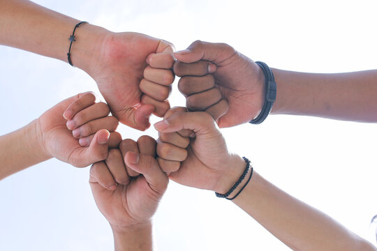 Closeup of People Doing Fist Bump Together in a Circle - Powered by Adobe