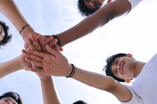 Group of People Stacking Hands Together Outdoor. Community of Multiracial International People Supporting Each Other.