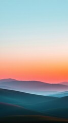 Fototapeta premium Sunrise over rolling hills with soft pastel colors in the sky