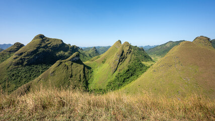 Fototapeta premium Set amidst majestic, undulating hills, Ba Quang Hill is of unique, wild and poetic beauty. Located about 70km east of Cao Bang city center, Ba Quang grass hill (also known as Vinh Quy grass hill) .