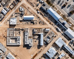 Aerial view of a complex construction site showing phased development, crane activity and material staging areas - report industry Steel Heavy