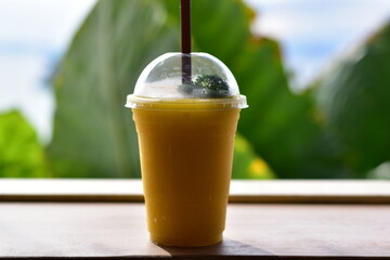 Mango Passion Fruit Smoothie with Sea View, Refreshing mango passion fruit smoothie by the beach at sunset