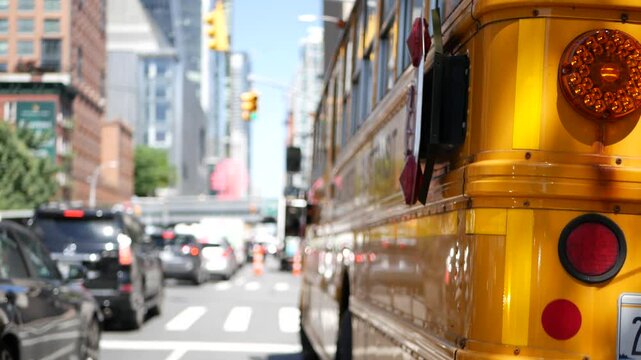 Yellow School Bus on New York Manhattan street, schoolbus truck on busy city road. Children education and transportation, USA. American school shuttle in traffic jam, 10 avenue Chelsea, United States.