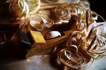 Hand planer with wooden sawdust. On a wooden background. High quality photo