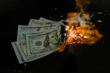 Stack banknote is burning on a black background