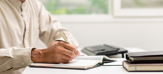 employee  writing on notebook during training course in company , skill for business concept