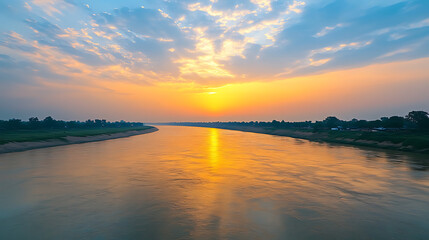 Obraz premium Beautiful river landscape with stunning sunset and reflections of clouds at dusk