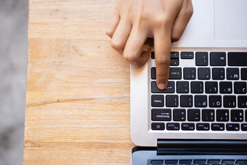 digital nomad is working in cafe, focused on laptop keyboard while enjoying productive atmosphere....