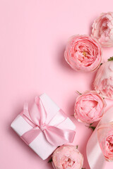 Beautiful pink peony roses with gift box on color background, space for text