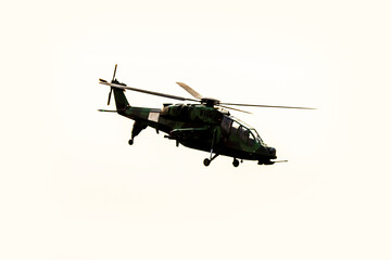 Fototapeta premium Silhouette helicopter is flying on isolated white background