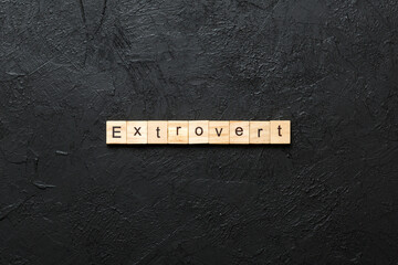 extrovert word written on wood block. extrovert text on table, concept